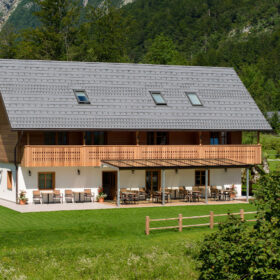 Privillage Stare – Bed and Breakfast Country House at Lake Bohinj, showcasing traditional Alpine wooden balconies, a spacious outdoor terrace, and stunning mountain scenery in Bohinj.