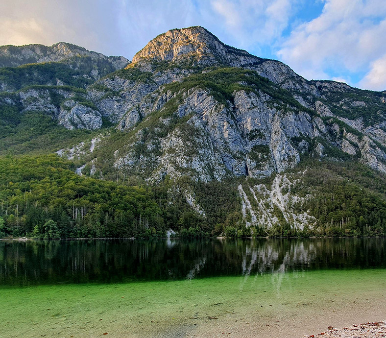 Summer view of Lake Bohinj with mountains near Privillage Stare
