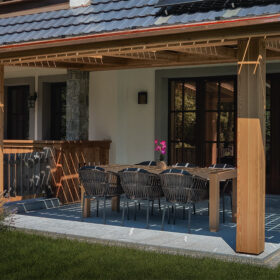 Covered terrace of the Luxury Alpine Villa in Bohinj with outdoor seating and dining area.
